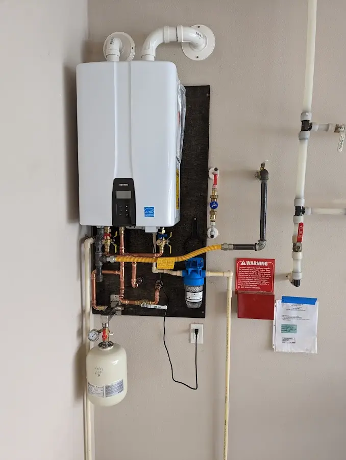 Professional plumber installing copper piping in a Mantua home